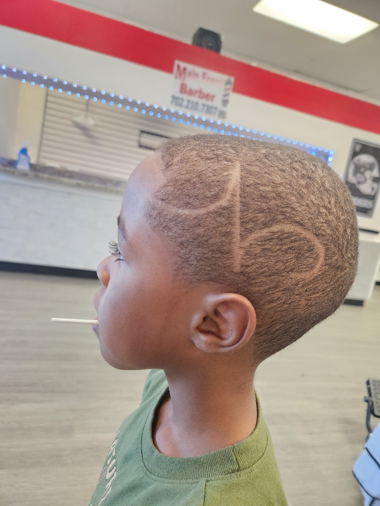 Side profile of a young boy with hair design detailing and a fade haircut